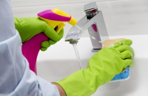 Sink being cleaned with sponge by Pure Cleaning commercial cleaners